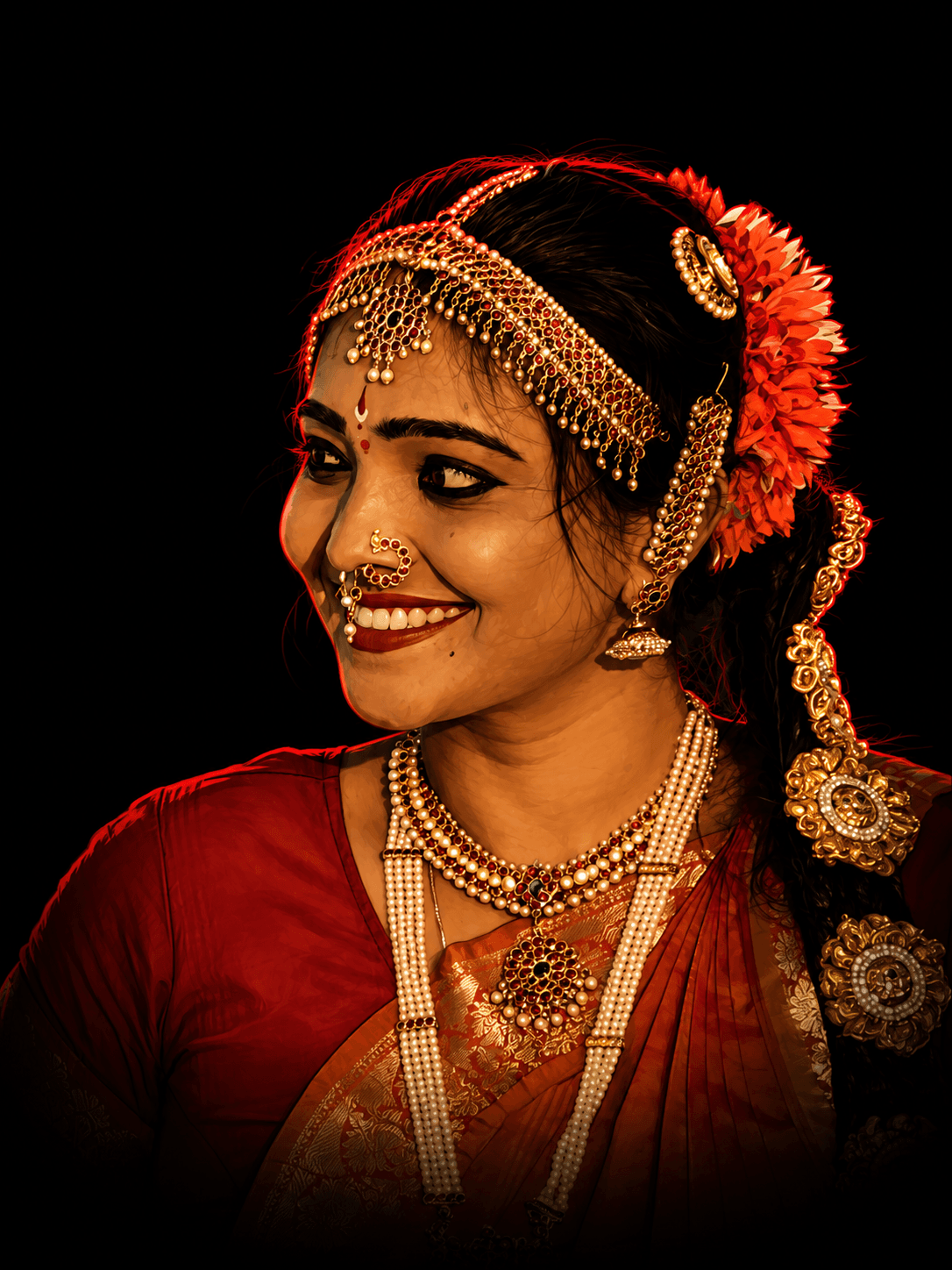 Portrait of Guru Dr. Sravani in classical Kuchipudi adornments with a marigold garland and gold jewellery
